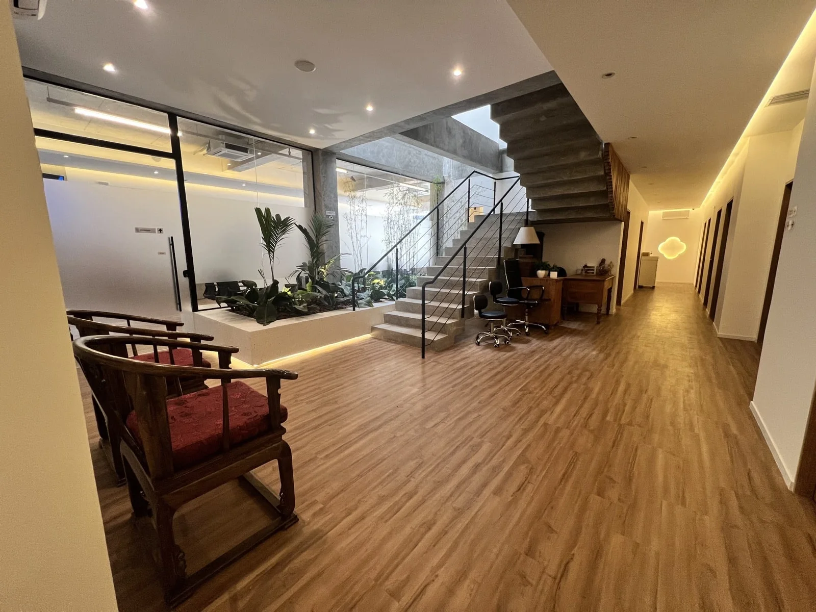 Recepção da clínica, com jardim interno e acesso aos consultórios